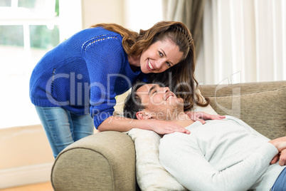 Young couple smiling in living room