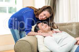 Young couple smiling in living room