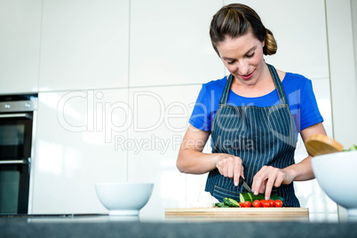 smiling woman preparing vegetables for dinner