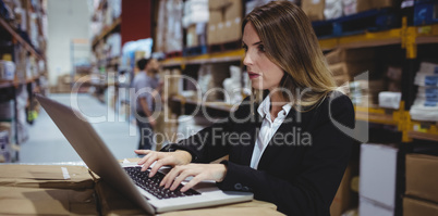 Warehouse manager using laptop