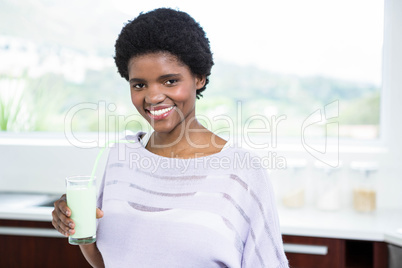 Pregnant woman drinking a glass of milk