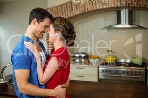 Romantic couple standing face to face and embracing each other