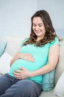 Pregnant woman sitting on couch