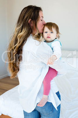smiling woman kissing an adorable baby