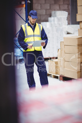 Portrait of warehouse worker with clipboard