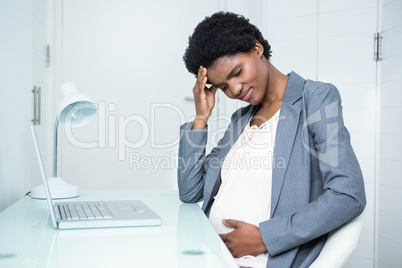 Pregnant businesswoman feeling sick