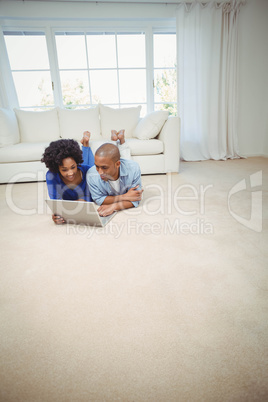 Smiling couple lying on the floor