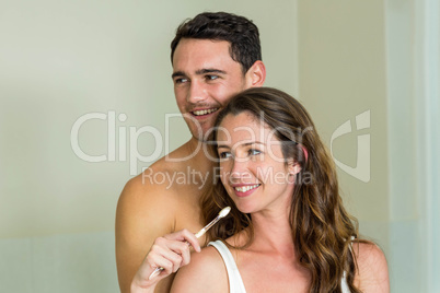 Young couple brushing their teeth at home