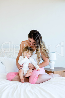 smiling brunette woman holding a cute baby