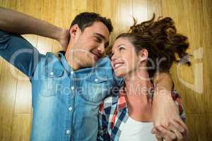 Young couple lying on floor in their house