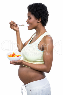 Pregnant woman eating fruit salad