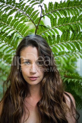 Portrait of beautiful woman standing outdoors in garden