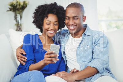 Happy couple using smartphone