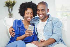 Happy couple using smartphone