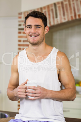 Portrait of young man holding a cup of tea