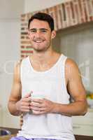 Portrait of young man holding a cup of tea