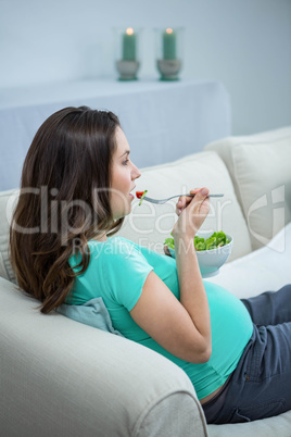 Pregnant woman eating salad