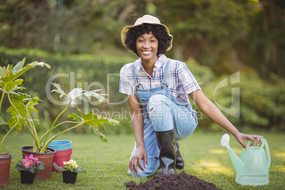 Smiling woman crouching in the garden