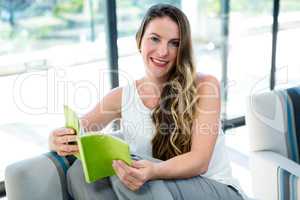smiling woman reading a book