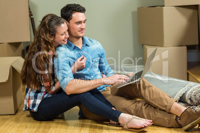 Young woman sitting on floor and using laptop Young woman sitting on floor and using laptop
