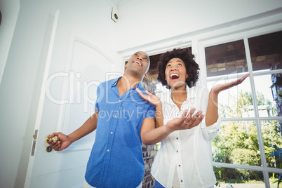 Happy couple entering in their house