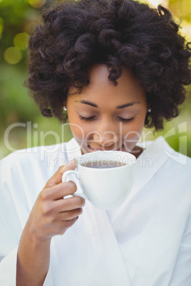 Smiling woman drinking coffee