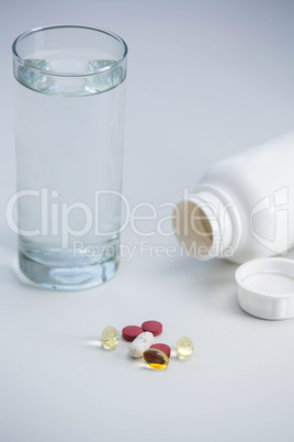 Pills beside glass of water