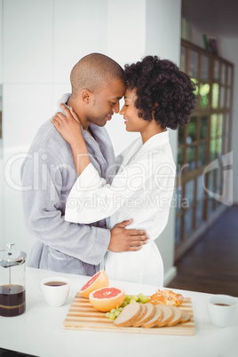 Happy couple hugging in the kitchen