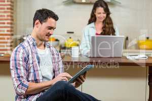 Man using digital tablet in kitchen