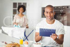 Young man using tablet in kitchen