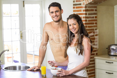 Young couple having breakfast in kitchen
