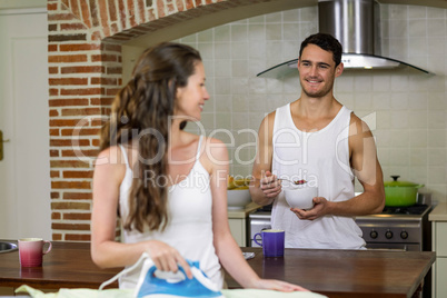 Man talking to woman while having breakfast