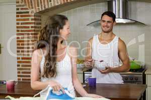 Man talking to woman while having breakfast