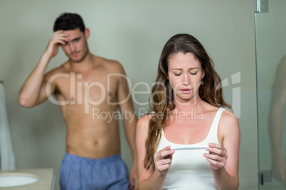 Sad couple after checking pregnancy test results