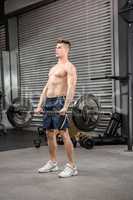 Shirtless man lifting barbell