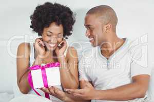Handsome man giving present to his girlfriend