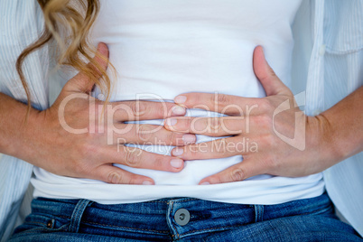 woman clutching her stomach in discomfort