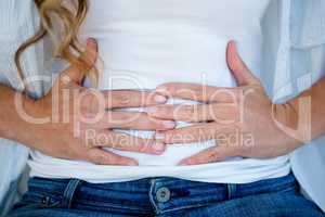 woman clutching her stomach in discomfort