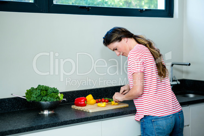 thoughtfull woman preparing vegetables for dinner