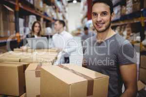 Smiling man carrying box