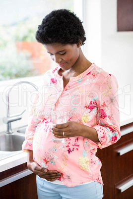 Pregnant woman holding glass of water