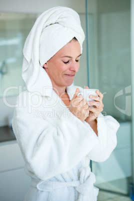 woman wearing a dressing gown smiling at the camera