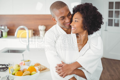 Happy couple hugging in the kitchen