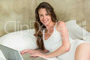 Beautiful brunette woman using laptop