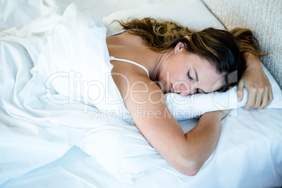 peaceful woman asleep in her bed