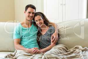 Young couple embracing on sofa