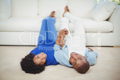 Happy couple lying on the floor