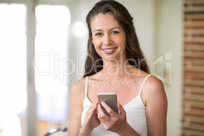 Happy young woman using smartphone