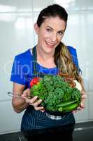 woman holding vegetables