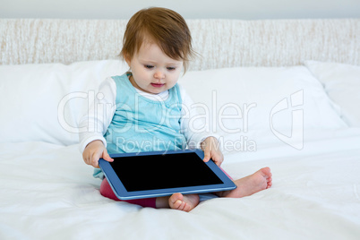 adorable baby holding aa tablet computer